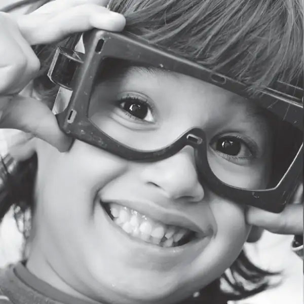 boy with googles smiles big